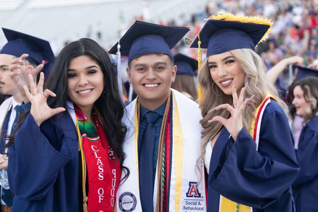 Three students in cap and gowns